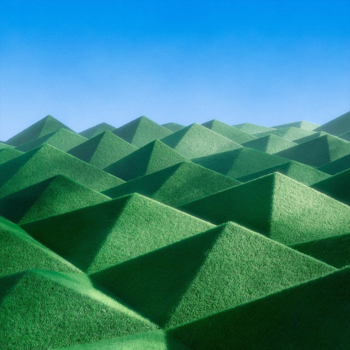 Layered green hills beneath a blue sky